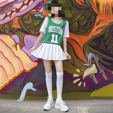 Eleven green blouses and one white dress